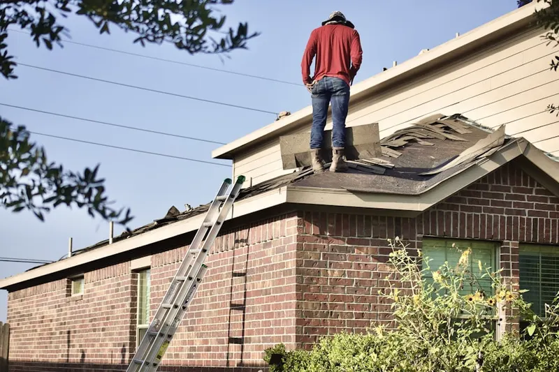 Professional roofer working on a residential roof in Estherville